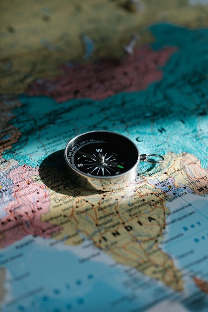 A close-up shot of a compass resting on a map of India, symbolizing exploration and travel.